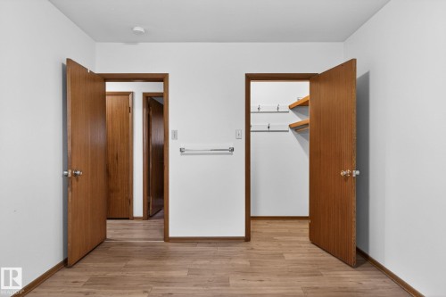Wood-finish flooring throughout, complemented by white walls - 13920 64 Street, Edmonton, AB 
