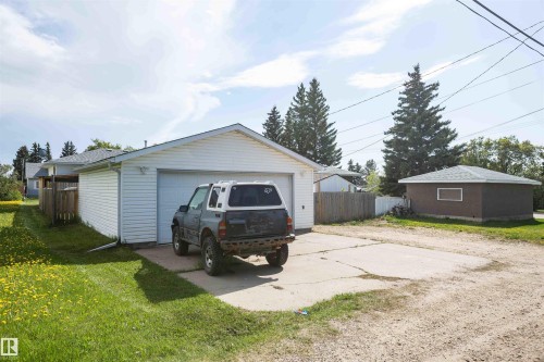 Detached two-car garage with white siding and an additional detached brown accessory building - 4414 54 Avenue, Barrhead, AB - Outdoor