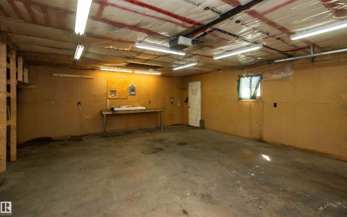 Spacious utility room featuring concrete flooring and exposed ceiling beams - 4414 54 Avenue, Barrhead, AB - Indoor Photo Showing Basement