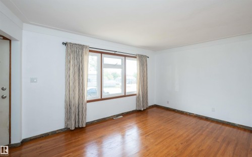 Hardwood flooring throughout - 4414 54 Avenue, Barrhead, AB - Indoor Photo Showing Other Room