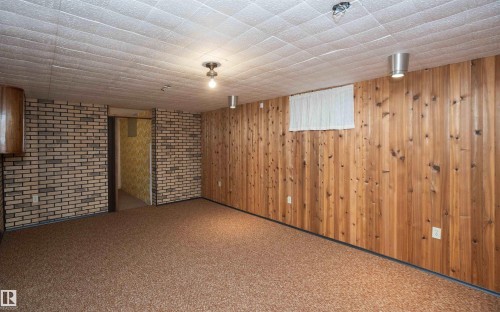 Finished room featuring textured carpet flooring and a suspended acoustic tile ceiling - 4414 54 Avenue, Barrhead, AB - Indoor Photo Showing Other Room