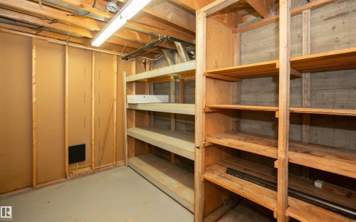 Extensive built-in wood shelving units provide ample storage capacity within this unfinished space - 4414 54 Avenue, Barrhead, AB - Indoor Photo Showing Basement