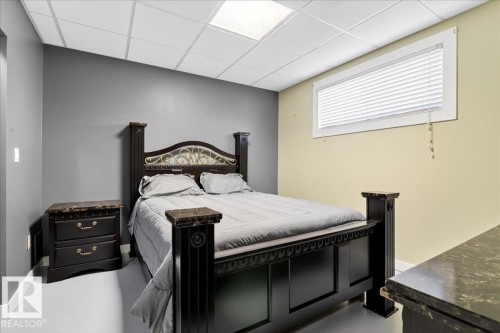 Bedroom featuring a drop ceiling with recessed lighting, a window with horizontal blinds, and a neutral wall color palette - 5019 48 Avenue, Chipman, AB - Indoor Photo Showing Bedroom