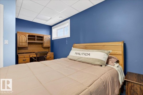 Room with blue painted walls and a drop ceiling - 5019 48 Avenue, Chipman, AB - Indoor Photo Showing Bedroom