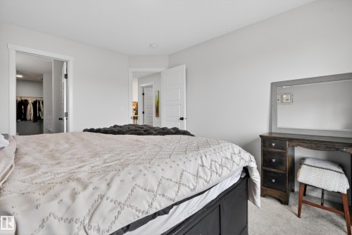 Bedroom featuring light gray wall paint, carpeting, and a white interior door with black hardware - 22836 94 Avenue, Edmonton, AB 