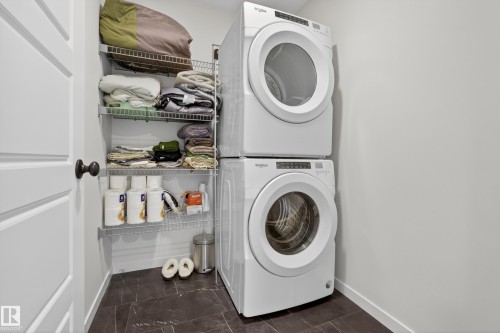 Dedicated laundry area featuring a stacked washer and dryer unit - 22836 94 Avenue, Edmonton, AB 