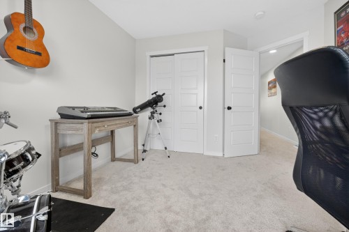 Light gray wall paint, light-colored carpet flooring, and white paneled doors - 22836 94 Avenue, Edmonton, AB 