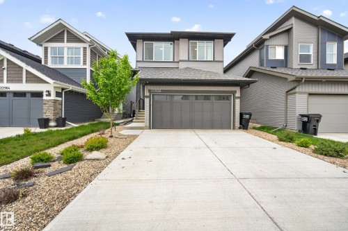 Contemporary two-story residence featuring a two-car attached garage with a concrete driveway - 22836 94 Avenue, Edmonton, AB 