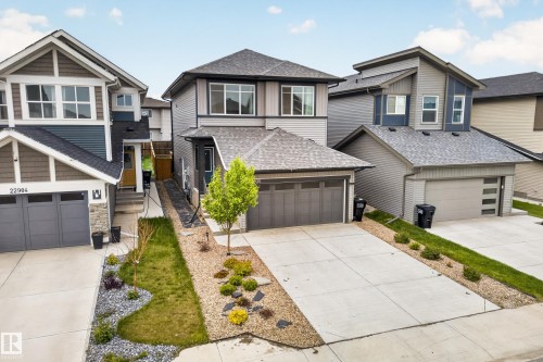 Contemporary two-story home featuring a grey exterior with varied siding textures - 22836 94 Avenue, Edmonton, AB 