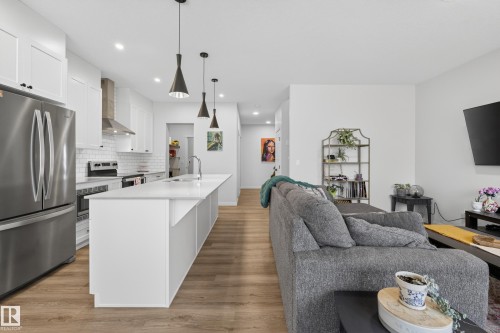 Open-concept kitchen and living area featuring wood-finish flooring - 22836 94 Avenue, Edmonton, AB 