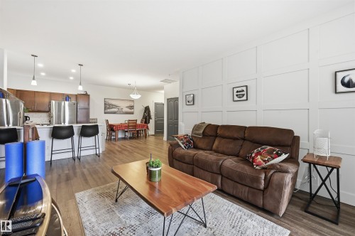 Open-concept living space with wood-finish flooring - 217 2503 Hanna Crescent, Edmonton, AB 