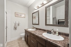 Dual vanity with undermount sinks and dark wood-finish cabinetry - 