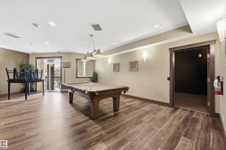 Spacious room featuring wood-finish flooring, recessed lighting, and a neutral color palette - 