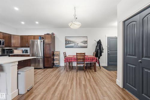 Open-concept living space with wood-finish flooring - 217 2503 Hanna Crescent, Edmonton, AB 