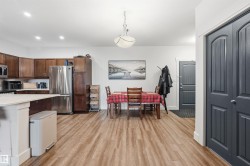 Open-concept living space with wood-finish flooring - 