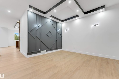 Accent wall featuring geometric paneling and integrated sconce lighting - 131 24 Street, Edmonton, AB 