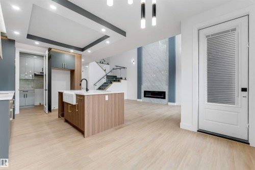 Open-concept living space with light wood-finish flooring - 131 24 Street, Edmonton, AB 