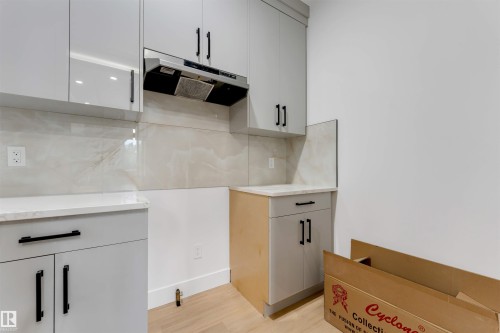 Newly installed kitchen cabinetry in a light gray finish with matte black hardware - 131 24 Street, Edmonton, AB 