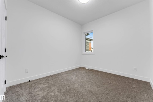 Neutral wall finishes and gray carpeting with white trim - 131 24 Street, Edmonton, AB 
