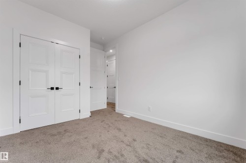 Interior space featuring plush gray carpeting and white walls - 131 24 Street, Edmonton, AB 
