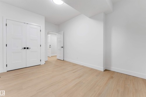 Light wood-finish flooring with white baseboards and walls - 131 24 Street, Edmonton, AB 