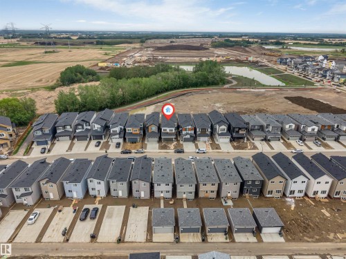 Modern residential development featuring multi-story homes with dark roofs and light-colored siding - 131 24 Street, Edmonton, AB 