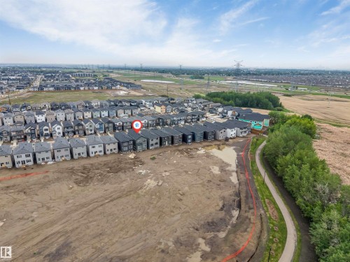 Aerial perspective showcasing a residential development with a mix of two-story homes featuring dark roofs - 131 24 Street, Edmonton, AB 