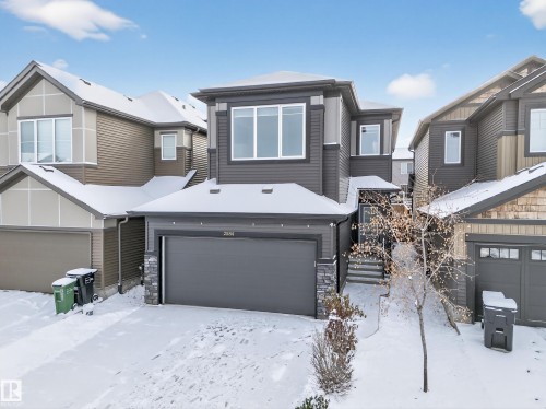 Two-story residential exterior featuring dark gray siding and stone accents - 2084 Graydon Hill, Edmonton, AB 