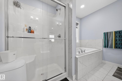 Shower enclosure with clear glass door, built-in shelf, and chrome fixtures - 2084 Graydon Hill, Edmonton, AB 