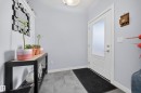 Entryway featuring wood-finish flooring and a contemporary white door with frosted glass panel - 2084 Graydon Hill, Edmonton, AB 