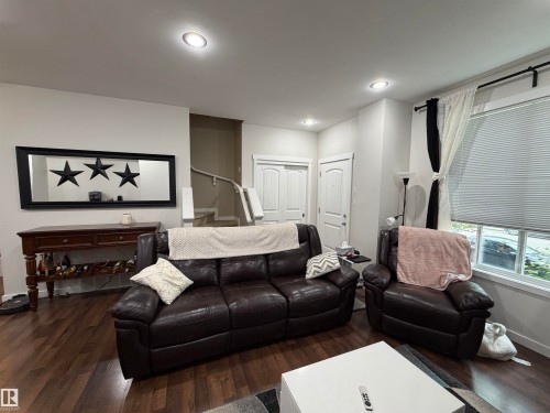 Spacious interior featuring recessed lighting, wood-finish flooring, and white paneled doors - 45 6075 Schonsee Way, Edmonton, AB 