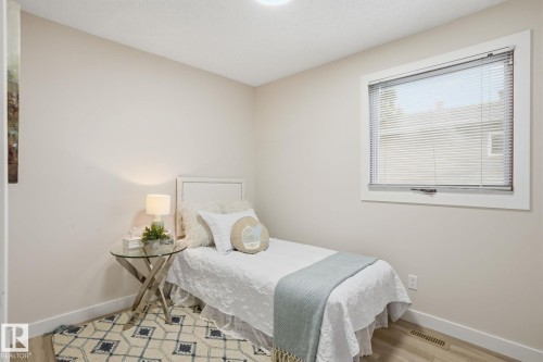 Bright room with a single window featuring white trim and horizontal blinds - 1008 61 Street, Edmonton, AB 