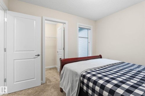 Neutral wall color with textured ceiling, white trim, and a window providing natural light - 20011 26, Edmonton, AB 