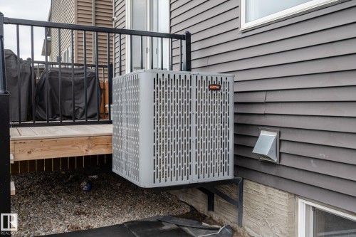 Modern outdoor HVAC unit with a grey slatted exterior, mounted on a black metal bracket - 20011 26, Edmonton, AB 