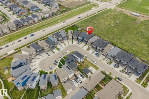 Aerial view of a residential community featuring a cul-de-sac and grid-pattern street layout, with properties bordering undeveloped land - 20011 26, Edmonton, AB 