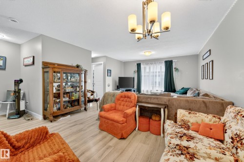 Open-concept living area featuring light wood-finish flooring throughout - 85 165 Cy Becker Boulevard, Edmonton, AB - Indoor Photo Showing Living Room