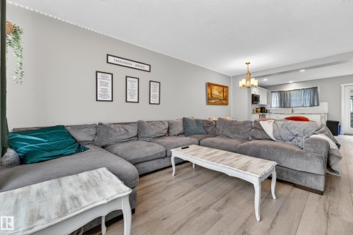 Open-concept living area with light-toned wood-finish flooring - 85 165 Cy Becker Boulevard, Edmonton, AB - Indoor Photo Showing Living Room