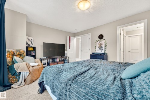 Carpeted bedroom with neutral wall tones and a textured ceiling - 85 165 Cy Becker Boulevard, Edmonton, AB - Indoor Photo Showing Bedroom