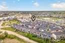 Aerial perspective showcasing a residential community with townhomes and detached properties - 85 165 Cy Becker Boulevard, Edmonton, AB  - Outdoor With View 