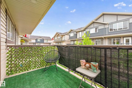 Private balcony featuring synthetic turf flooring, a metal railing, and a slatted privacy screen - 85 165 Cy Becker Boulevard, Edmonton, AB - Outdoor