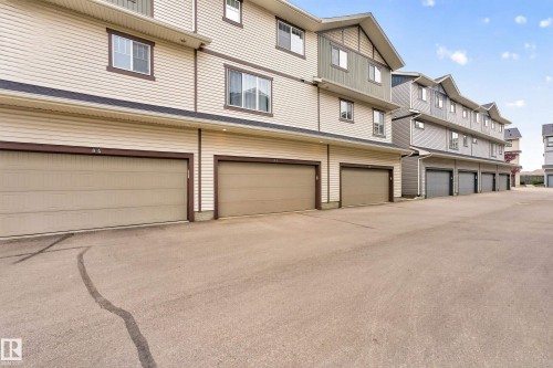 Townhome exterior featuring horizontal siding in a light neutral tone with contrasting trim - 85 165 Cy Becker Boulevard, Edmonton, AB - Outdoor