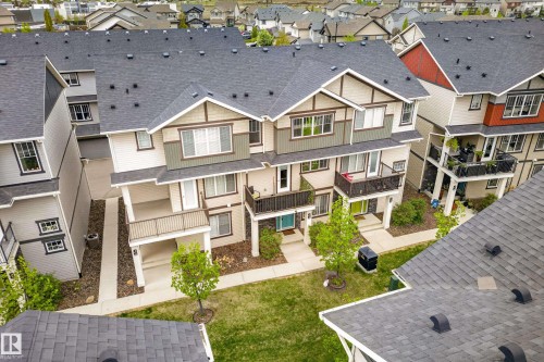 Multi-level townhome featuring a neutral-toned facade with contrasting trim, multiple balconies, and a covered entry porch - 85 165 Cy Becker Boulevard, Edmonton, AB - Outdoor With Facade