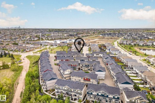 Aerial perspective showcasing a residential community with townhomes and detached properties - 85 165 Cy Becker Boulevard, Edmonton, AB - Outdoor With View