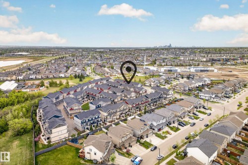 Aerial perspective showcasing a residential community with townhomes and detached properties - 85 165 Cy Becker Boulevard, Edmonton, AB - Outdoor With View