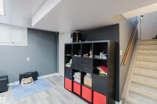 Lower level room featuring light wood-finish flooring and a window with blinds - 11158 65 Street, Edmonton, AB 