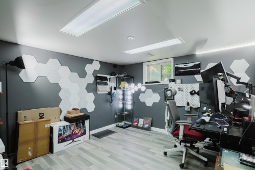 Room featuring light wood-finish flooring and dark gray walls - 11158 65 Street, Edmonton, AB 