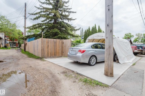 Concrete parking pad with a fabric carport structure - 11158 65 Street, Edmonton, AB 