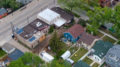 Aerial perspective showcasing a commercial building with a flat roof featuring solar panels - 11158 65 Street, Edmonton, AB 