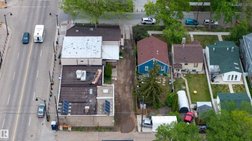Aerial perspective showcasing a multi-building property with varied roofing, including flat and sloped sections - 11158 65 Street, Edmonton, AB 