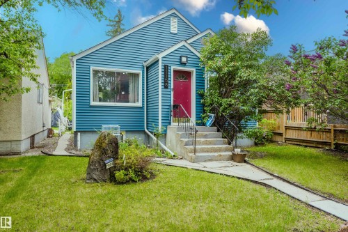 Blue horizontal siding exterior with a red front door - 11158 65 Street, Edmonton, AB 